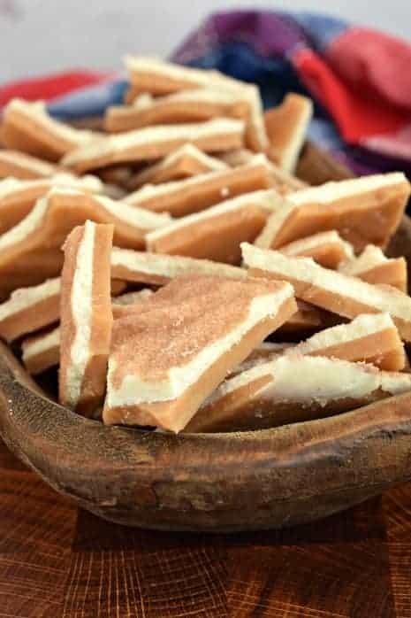 Wooden bowl filled with pieces of churro toffee.