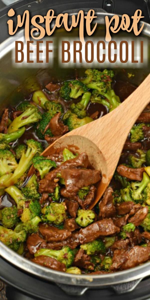 Beef broccoli in a skillet with a wooden spoon.