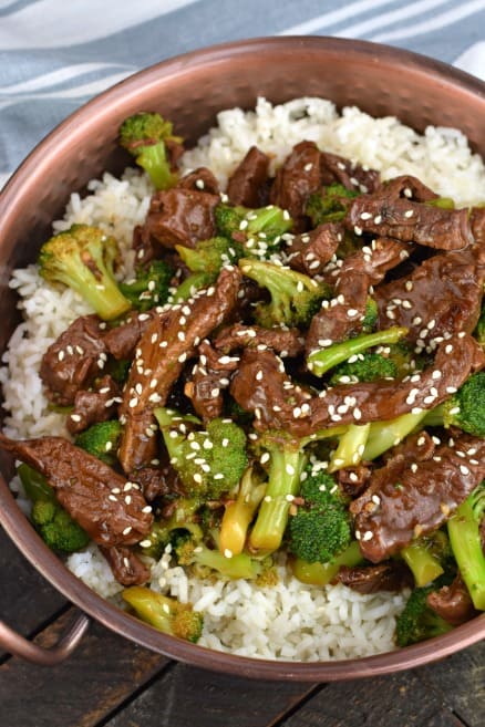 Copper bowl with white rice topped with Instant Pot cooked beef broccoli.
