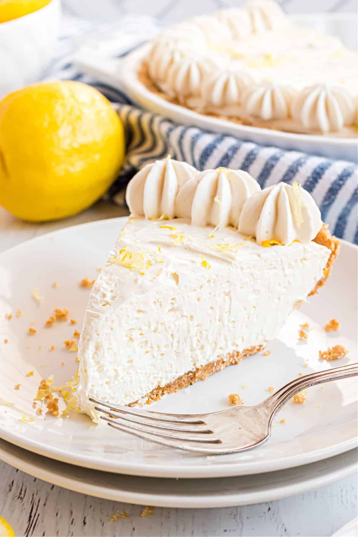 Slice of lemon cheesecake on a white plate.