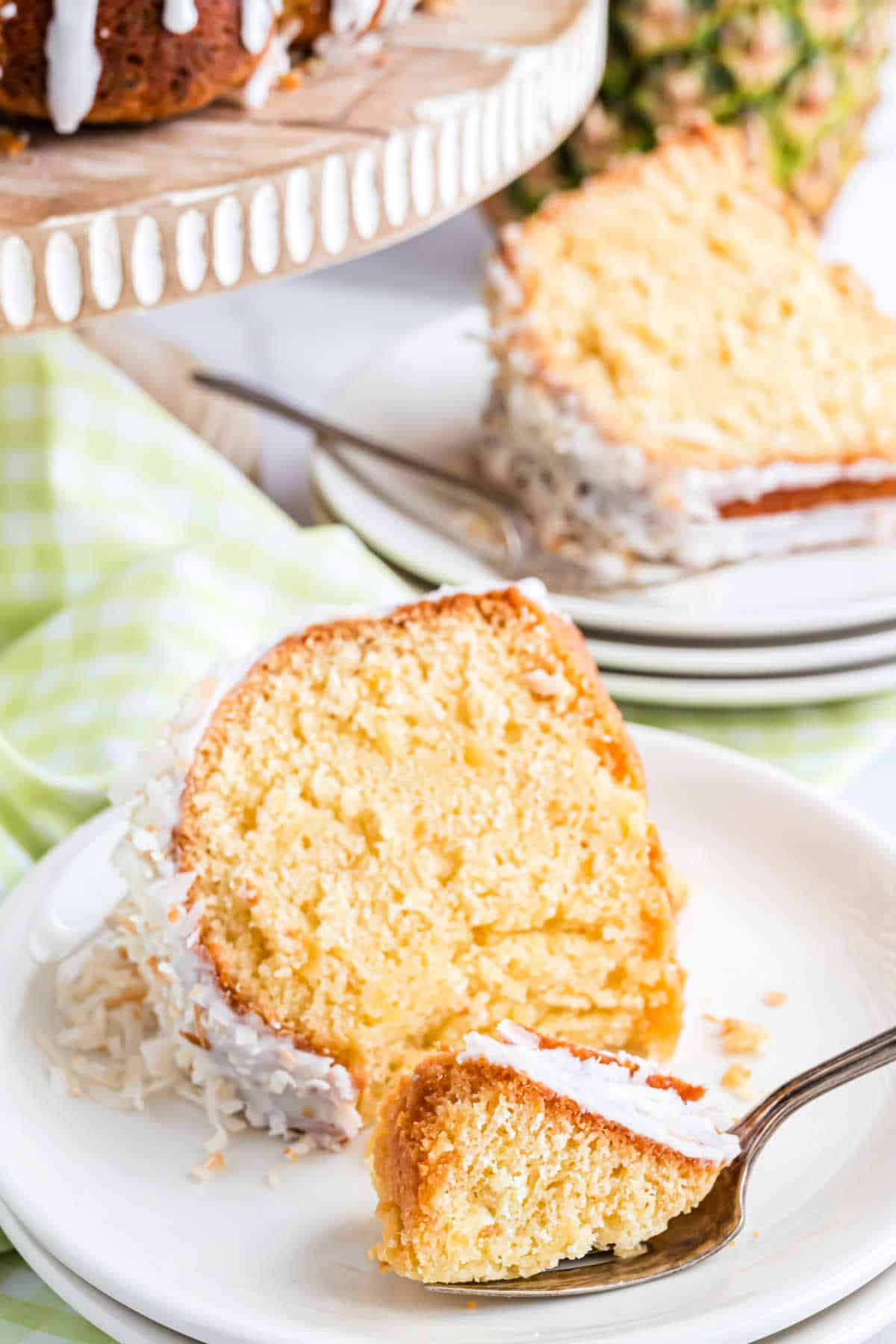 Slice of pineapple pound cake with a bite taken out.