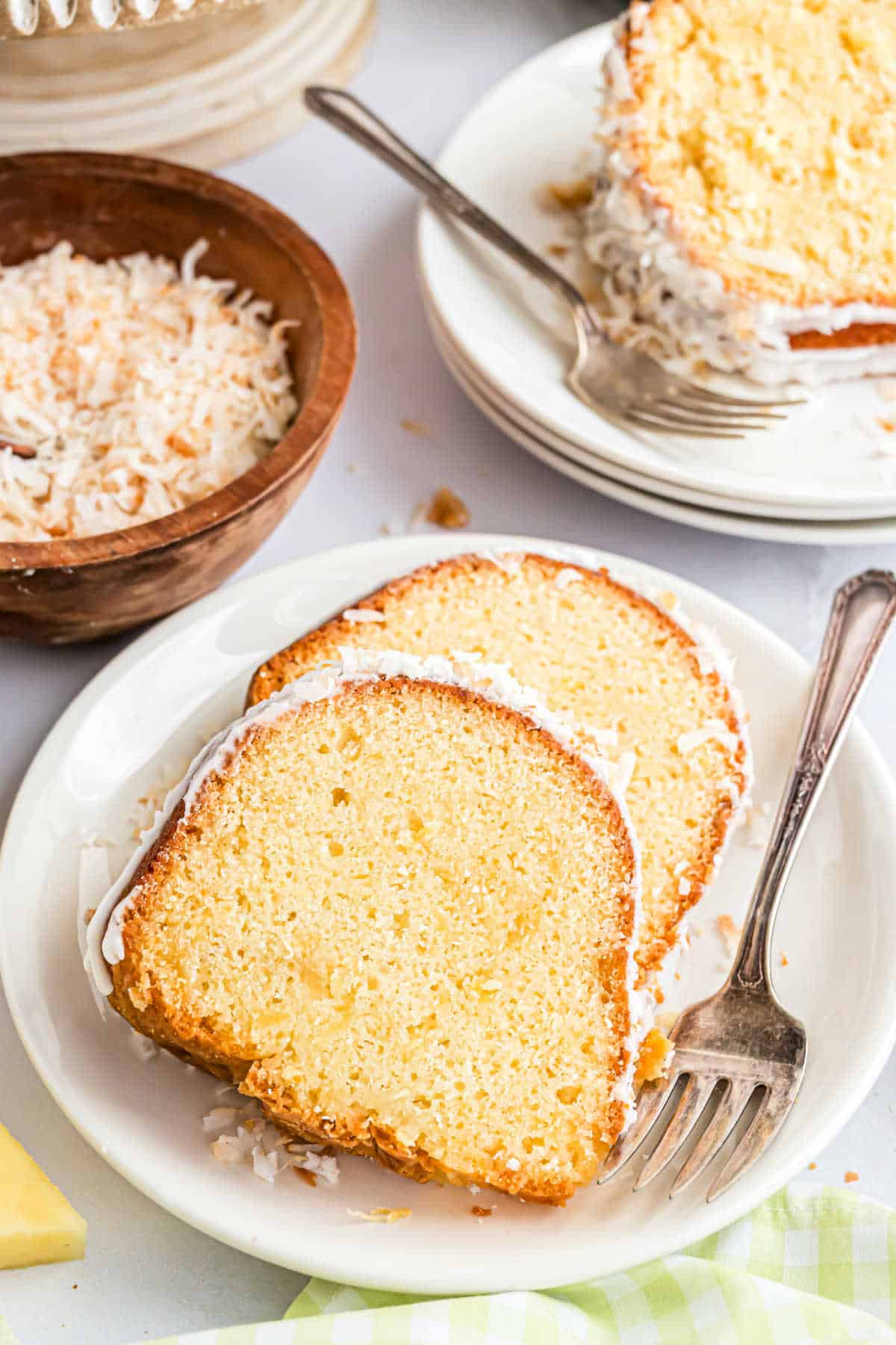 Two slices of pound cake on a white dessert plate.