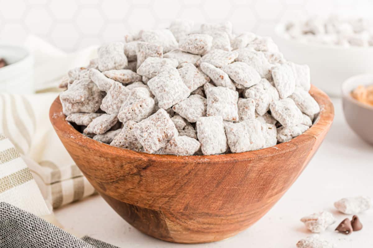 Muddy buddies served in a wooden bowl.