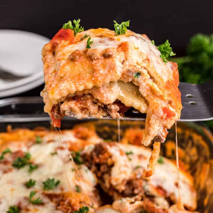 Easy, cheesy Baked Ravioli Lasagna Casserole Recipe. Serve up this comfort food for a quick, delicious weeknight dinner! Layered with cheese, frozen ravioli, and marinara sauce, this dinner is ready in minutes!