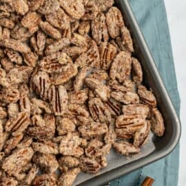 Candied pecans baked on a cookie sheet.