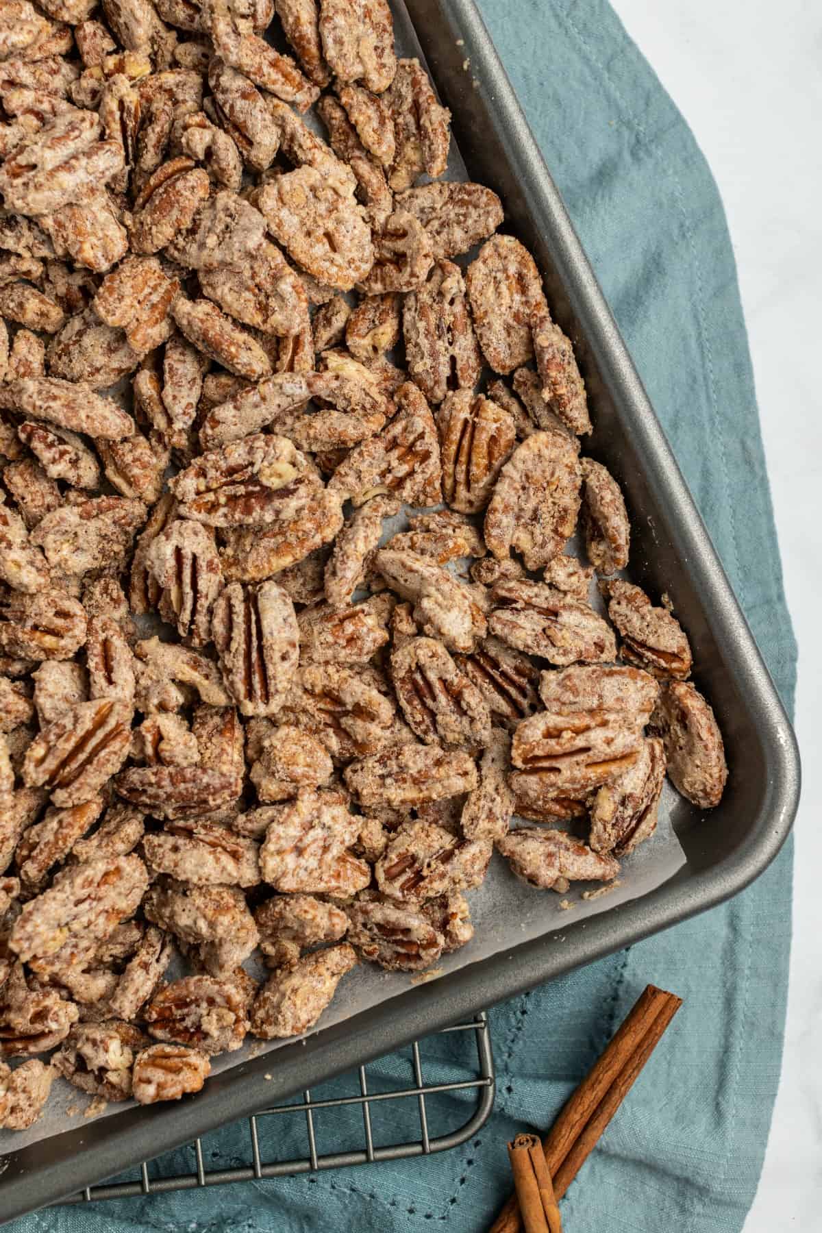 Candied pecans baked on a cookie sheet.