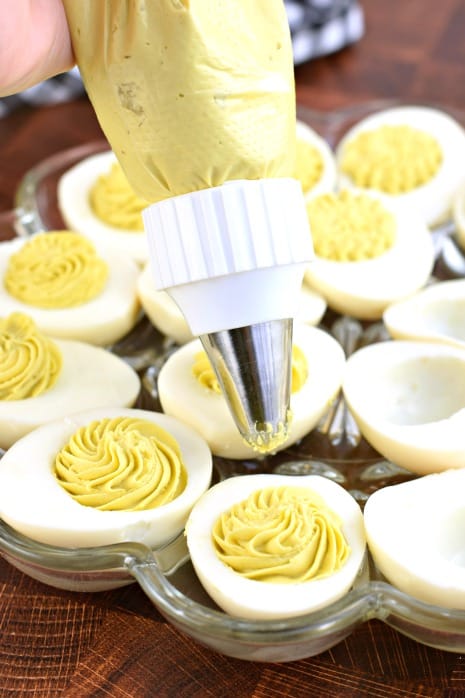 Clear piping bag filling with egg yolks, mayo, mustard, worcestershire sauce, and salt. Pipe into egg whites.