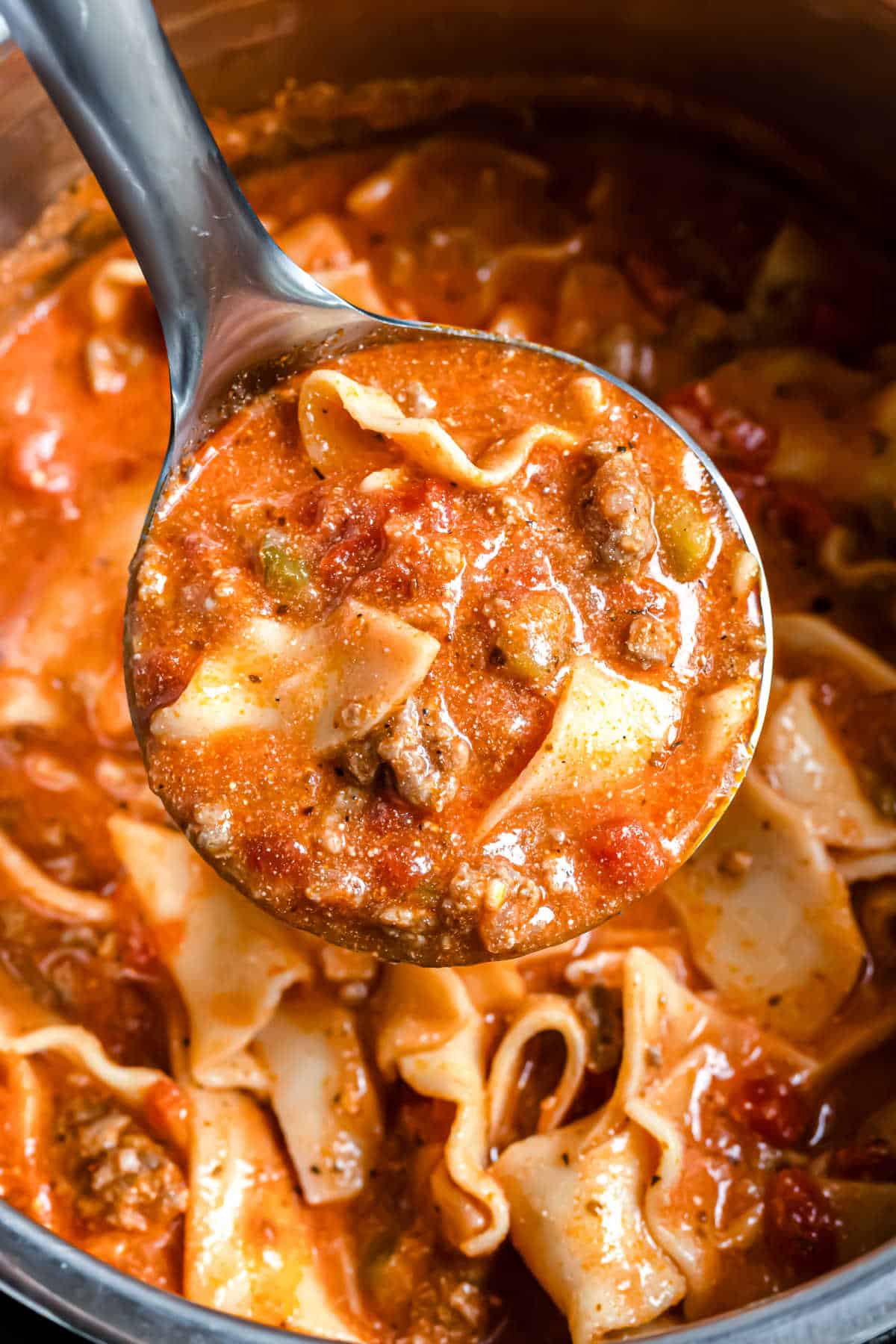 Ladle of lasagna soup in the pressure cooker.