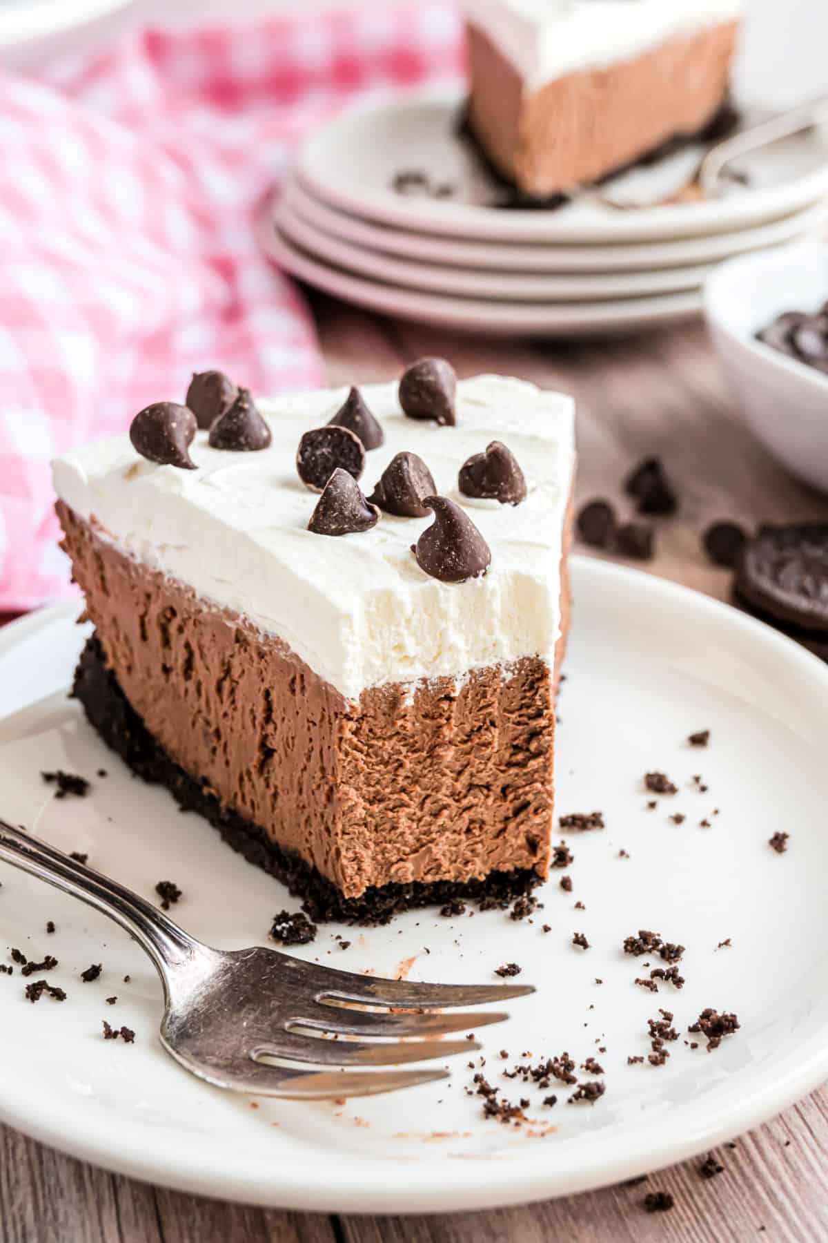 Slice of chocolate cheesecake with a bite taken out.