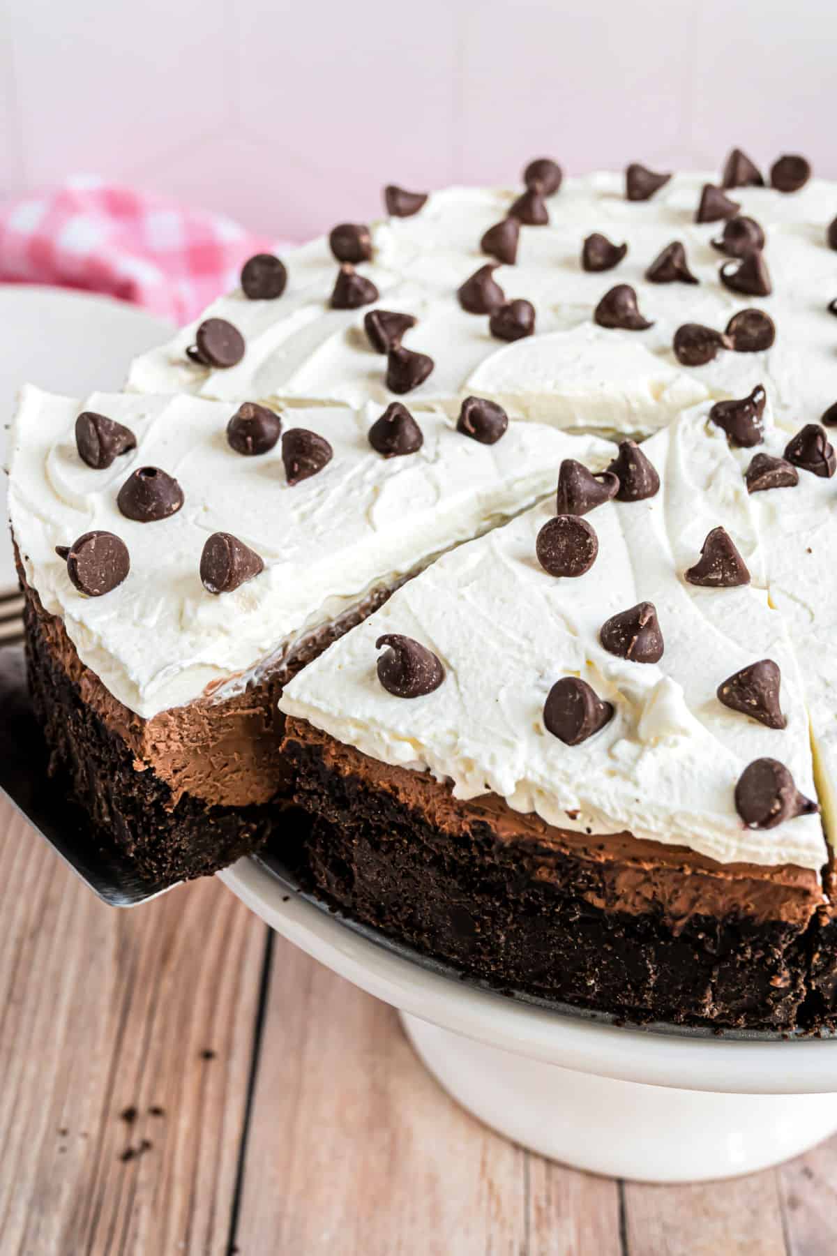 Chocolate cheesecake with a slice being removed.