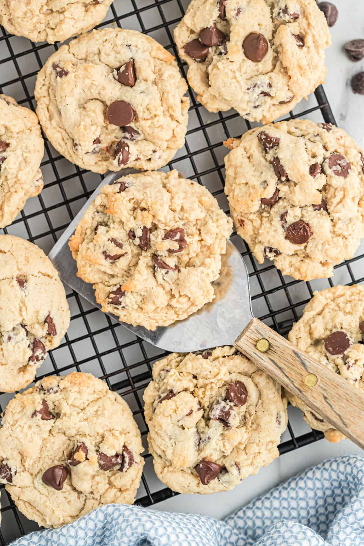 Chocolate chip cookies cooling on a wire rack.