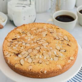 Swedish almond cake on a white serving plate.