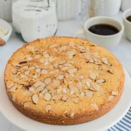 Swedish almond cake on a white serving plate.