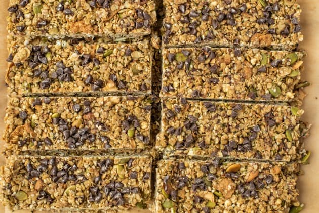 Tan parchment paper with cut chocolate chip granola bars.