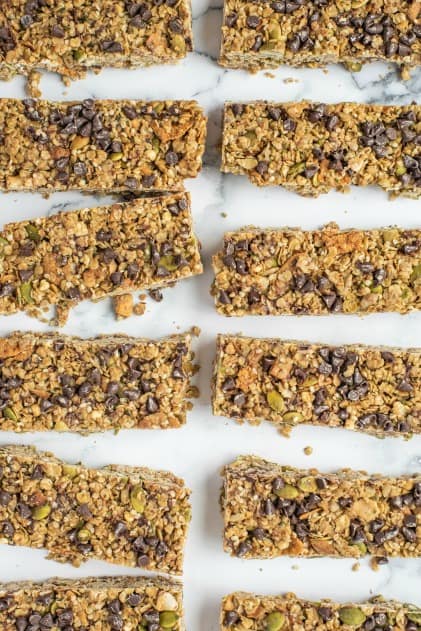 Marble counter lined with chocolate chip granola bars cut into rectangles.