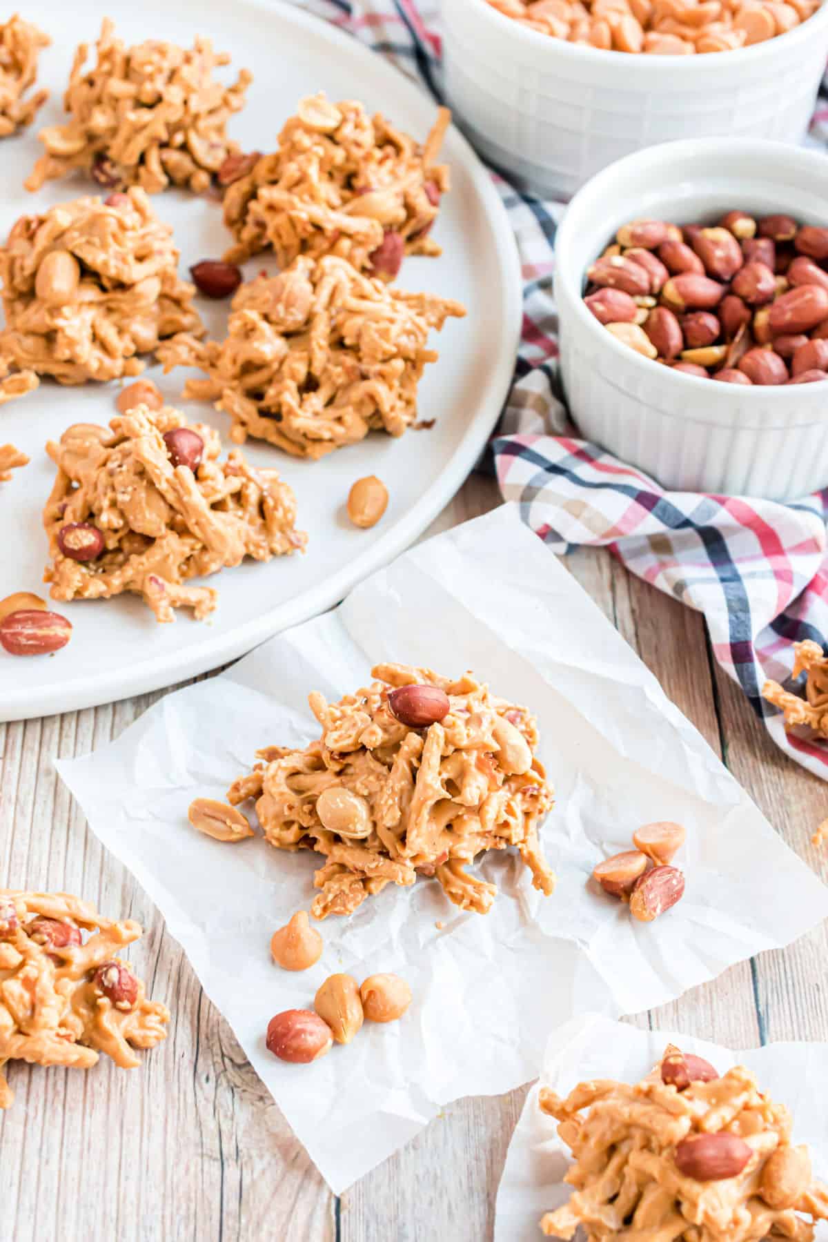 Haystack cookies with peanuts on parchment paper.