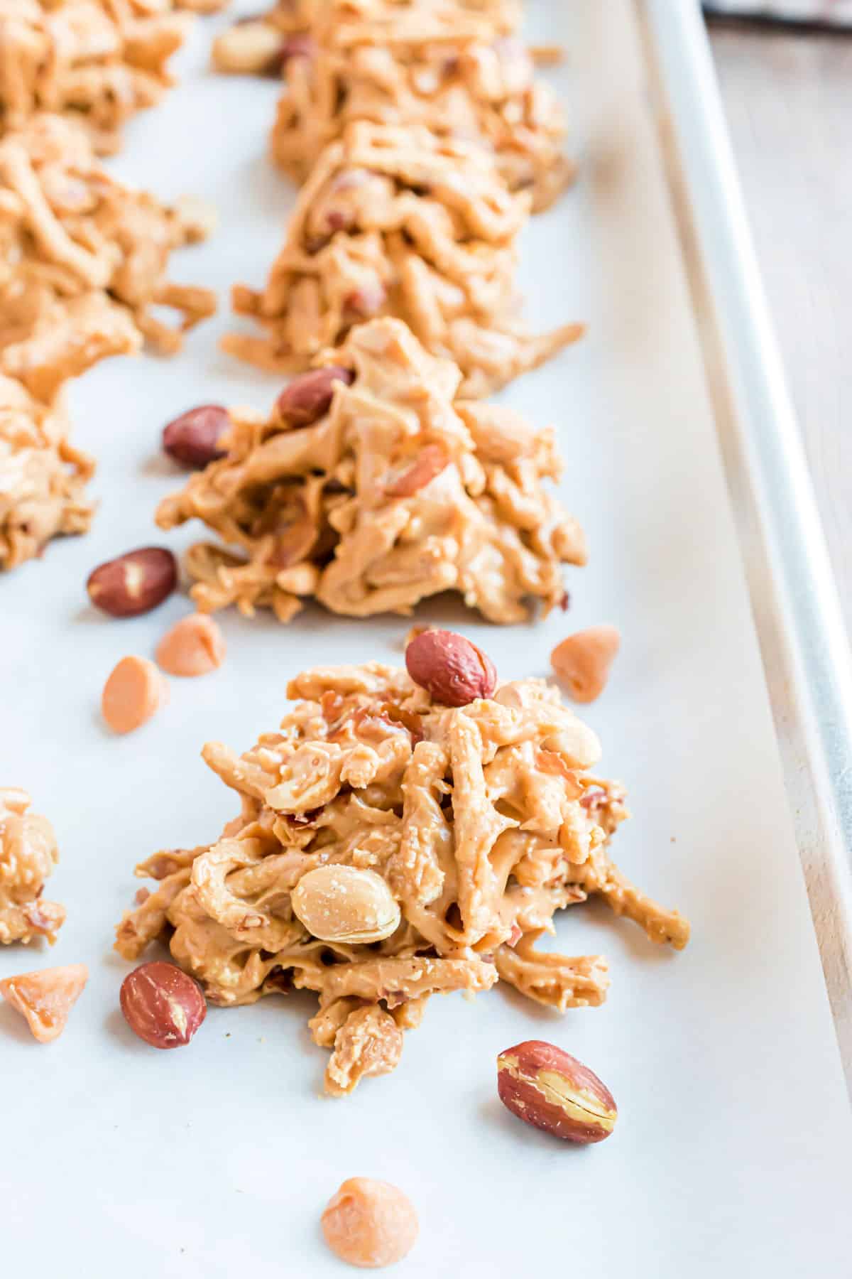 Chow mein cookies with butterscotch on parchment paper lined cookie sheet.