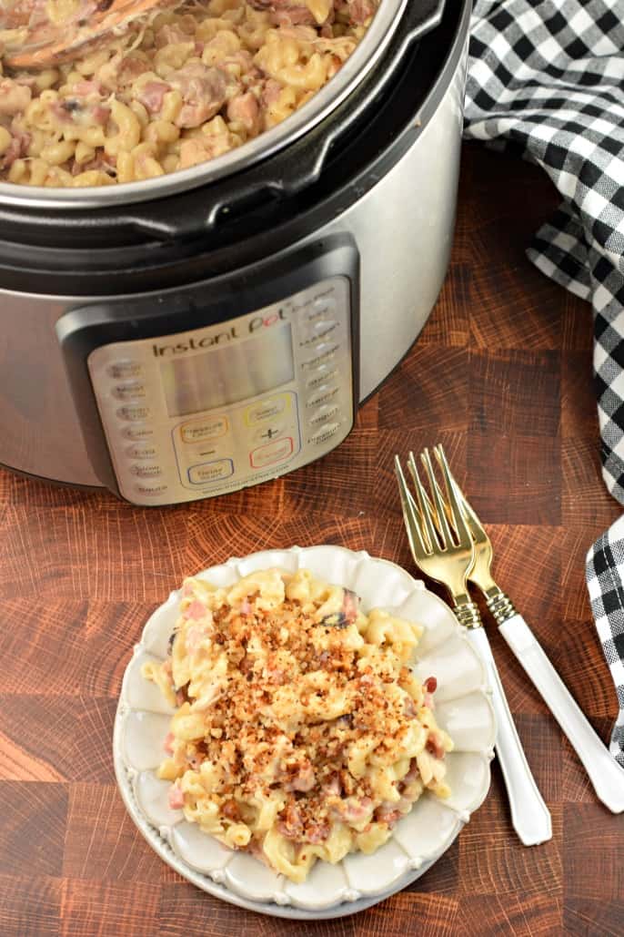 Plate with chicken cordon bleu and two forks. Instant Pot in background with remaining pasta.