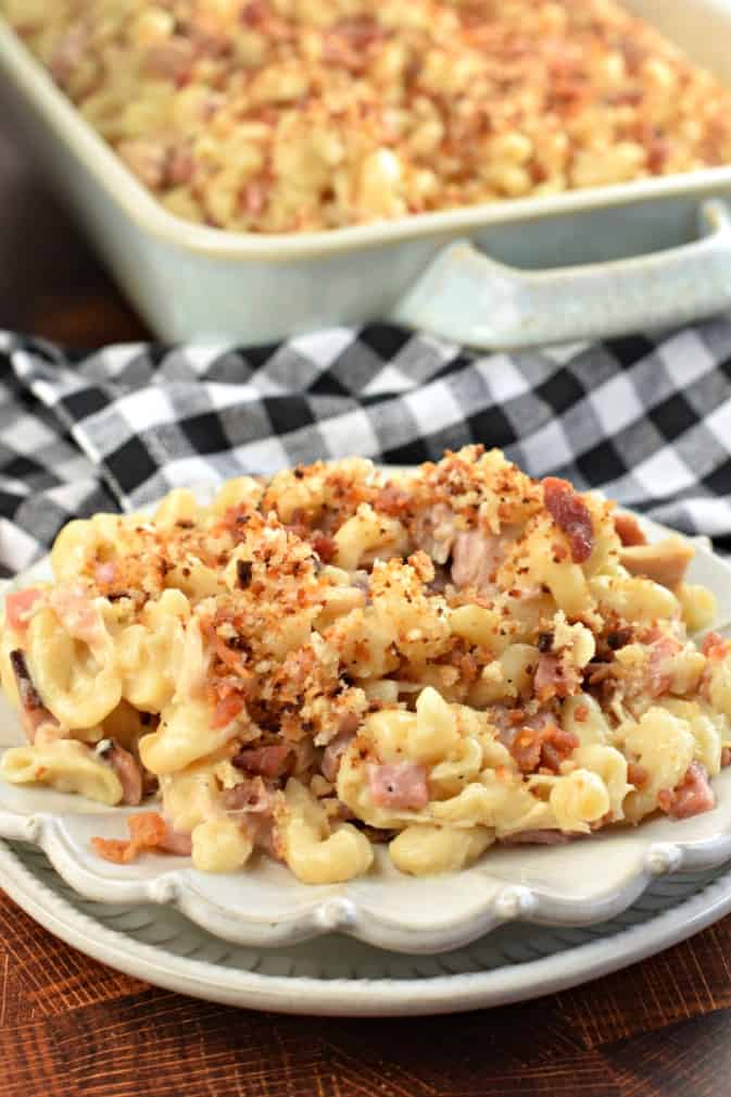 Scalloped dinner plate with a big scoop of chicken cordon bleu casserole topped with breadcrumbs.