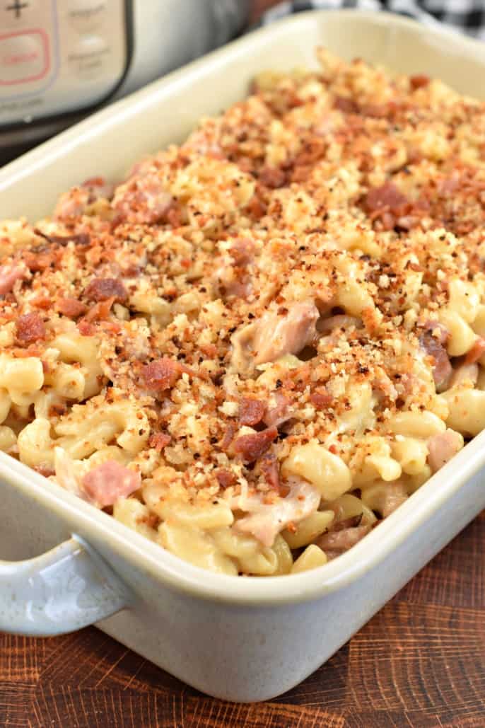 Rectangle casserole dish with chicken cordon blue casserole made in the Instant Pot and topped with breadcrumbs.