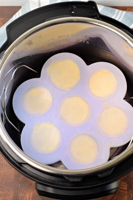 Instant Pot with a silicone egg bite mold inside on a metal trivet.