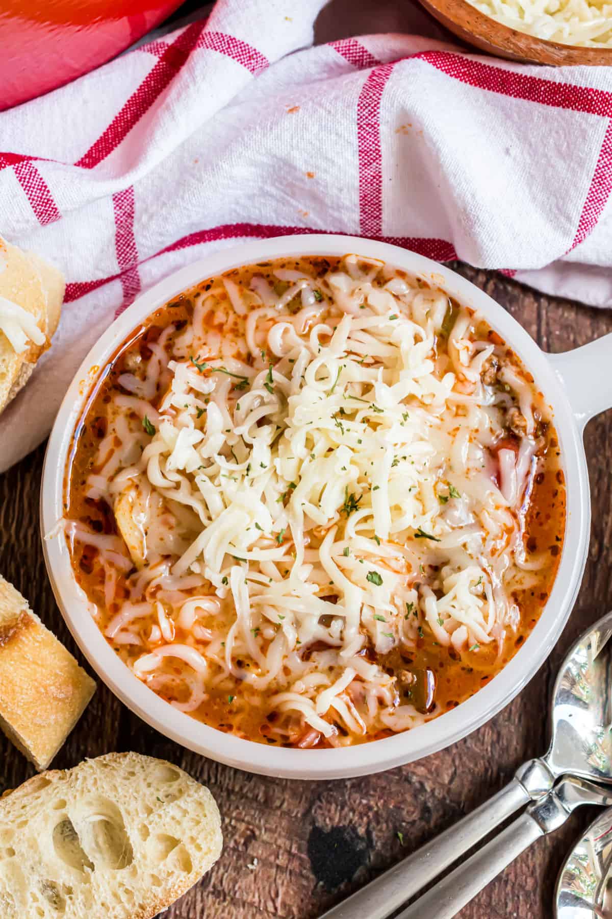 Dinner bowl with lasagna soup and melted cheese.