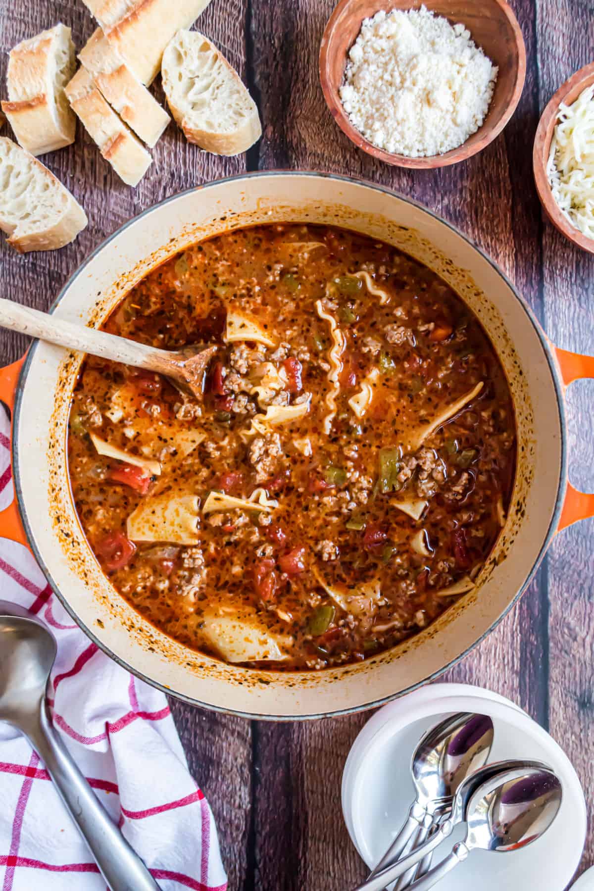 Lasagna soup in a large pot with a side of bread.