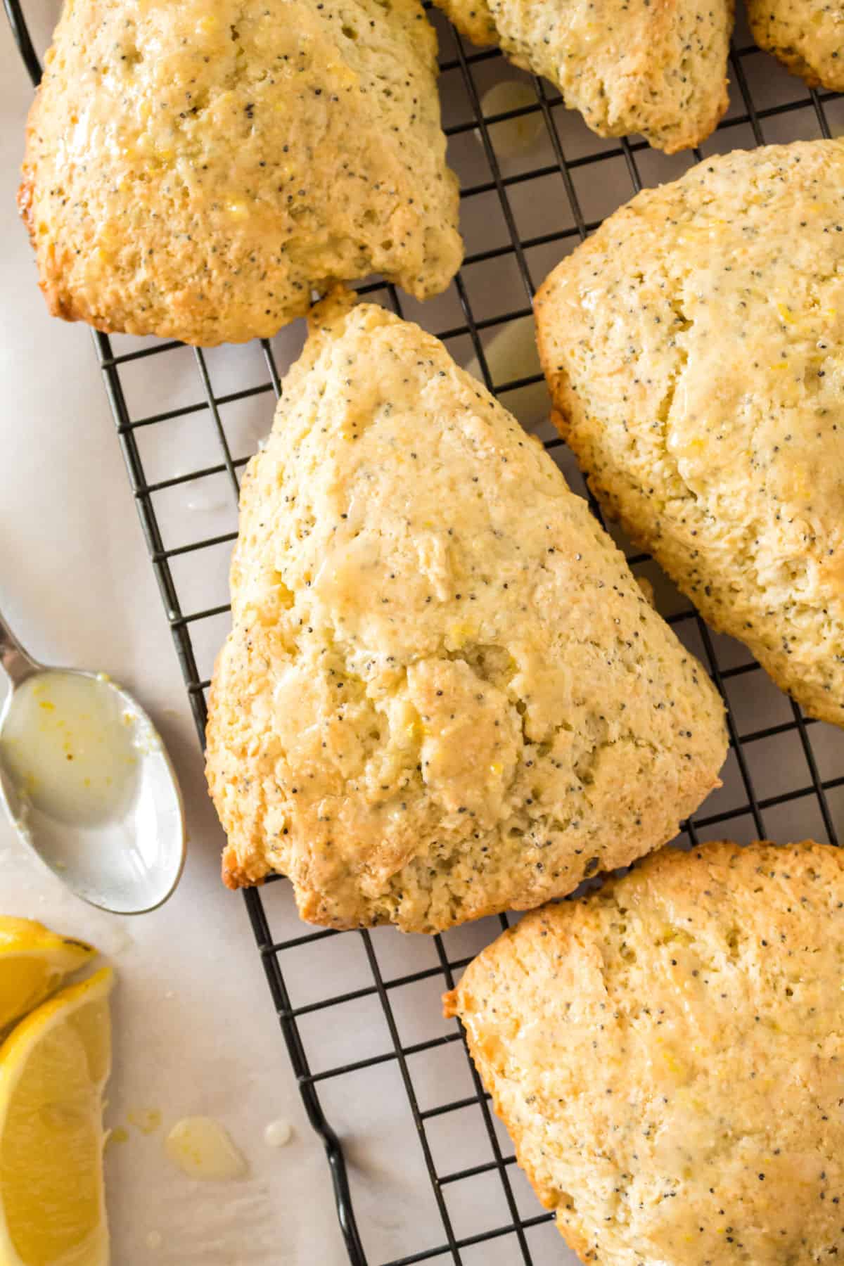 Lemon Sonces with poppy seeds and lemon glaze on wire cooling rack.