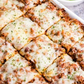 Million Dollar Spaghetti casserole in 13x9 baking dish cut into squares.