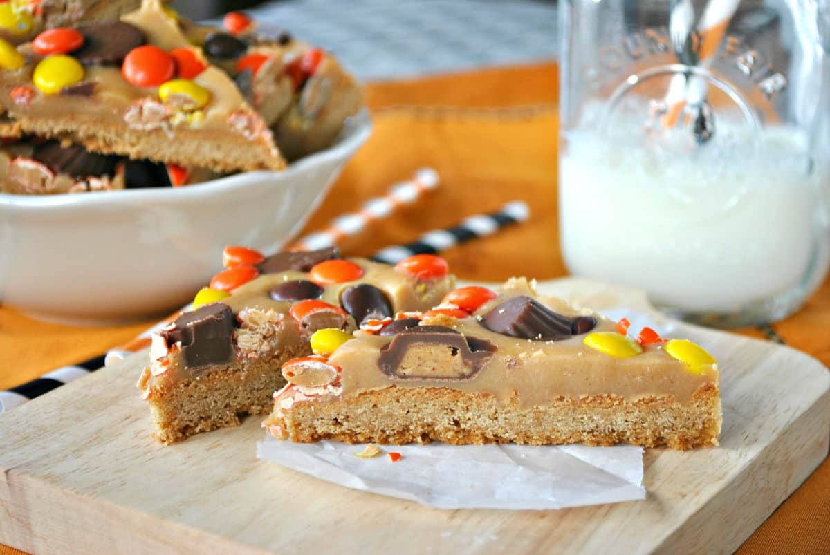 Peanut butter cookie bar with reeses cut into triangles.