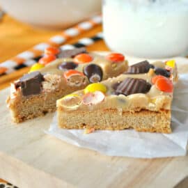 Perfect Peanut Butter Cookie Bars: Made with Reese's and peanut butter fudge on a peanut butter cookie crust! The kids will go nuts for these sweet homemade treats.