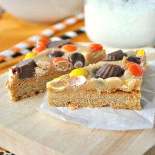 Perfect Peanut Butter Cookie Bars: Made with Reese's and peanut butter fudge on a peanut butter cookie crust! The kids will go nuts for these sweet homemade treats.