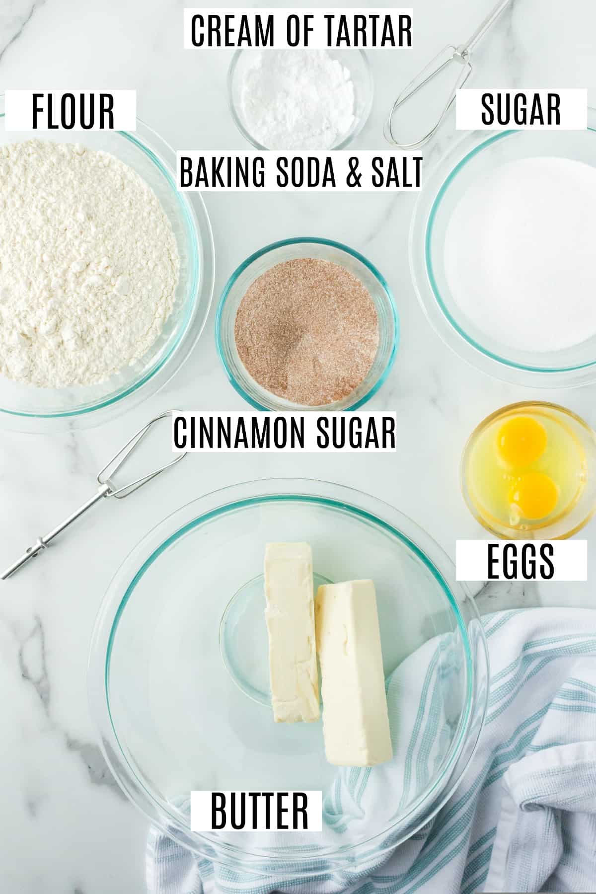 Ingredients needed to make snickerdoodles on a marble counter top.