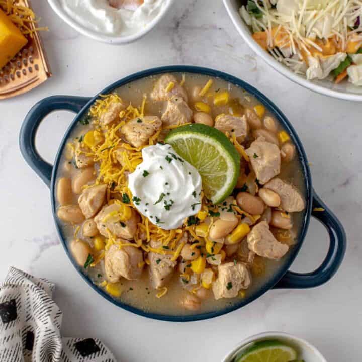 This White Chicken Chili has all the flavor of comfort food while being lower in fat than your average creamy chili. Enjoy a bowl for dinner tonight!!