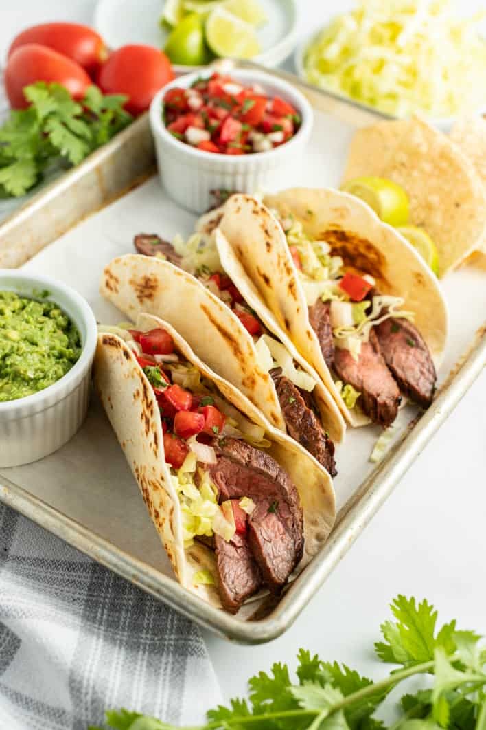 Tortillas filled with carne asada, lettuce, pico de gallo and cilantro. Served with homeamde guacamole.