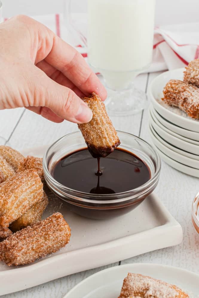 Homemade churros dipped in chocolate sauce.