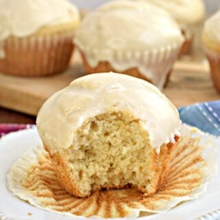 Glazed donut muffin with one bite removed.