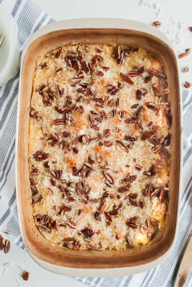 Baked peach dump cake in a 13x9-inch baking dish, topped with coconut and pecans.