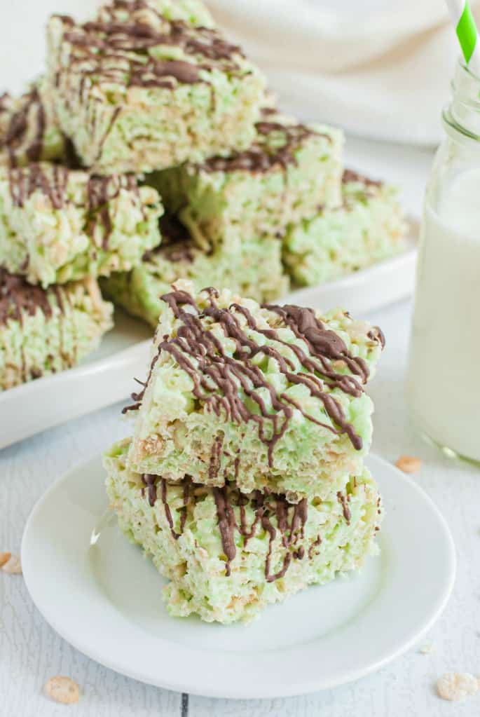 Stack of two pistachio rice krispies treats on a white plate.