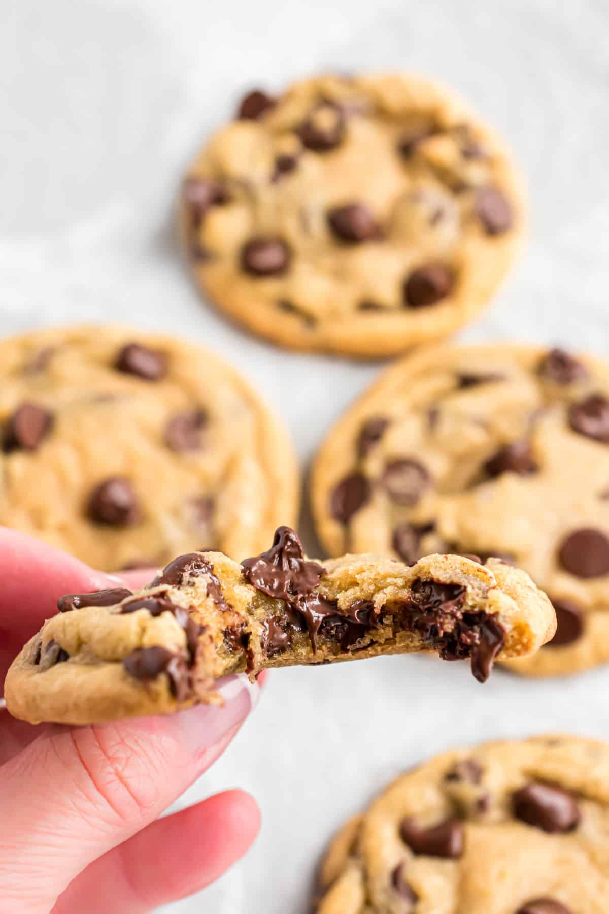 Chocolate chip cookies with a bite removed and melty chocolate.