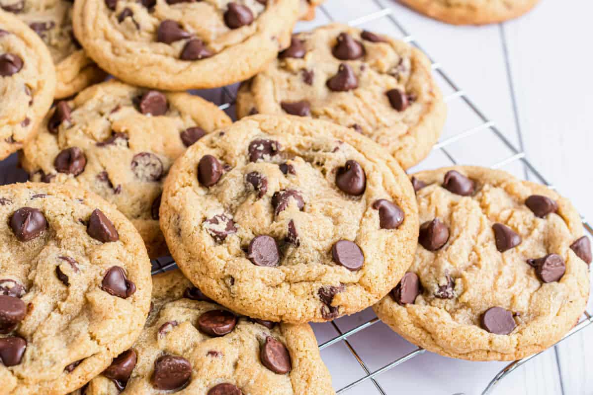 Chocolate chip cookies on a wire rack.