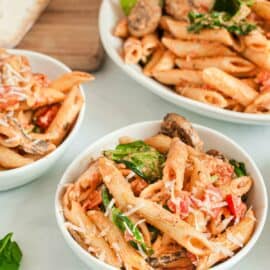 White bowls filled with homemade penne rosa.
