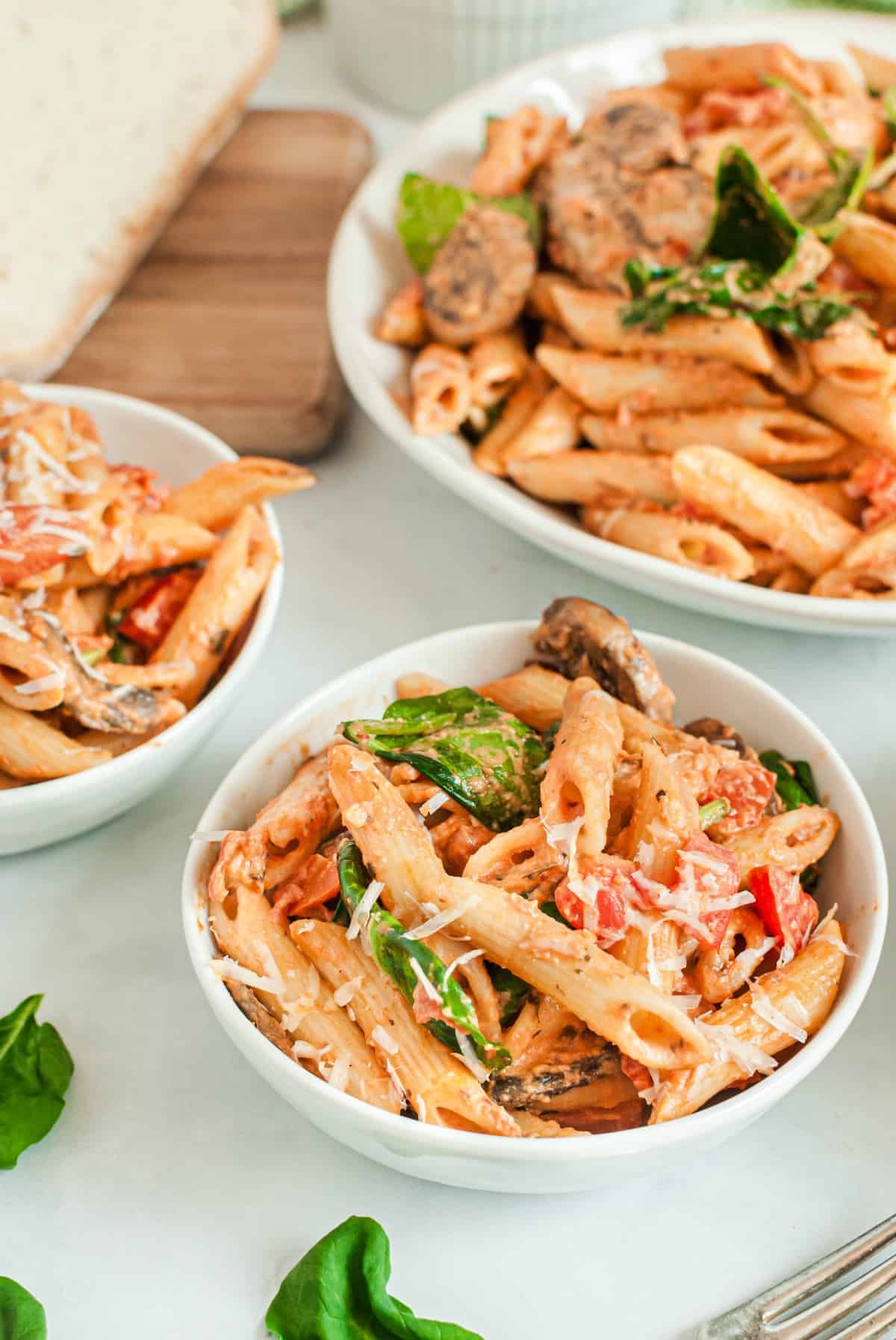 White bowls filled with homemade penne rosa.