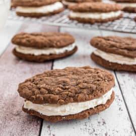 Chocolate oatmeal cream pie with filling on counter.