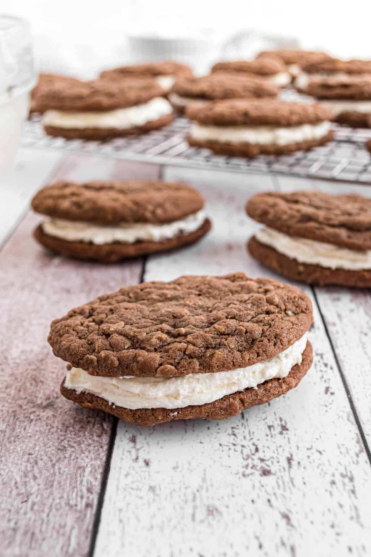 Chocolate oatmeal cream pie with filling on counter.