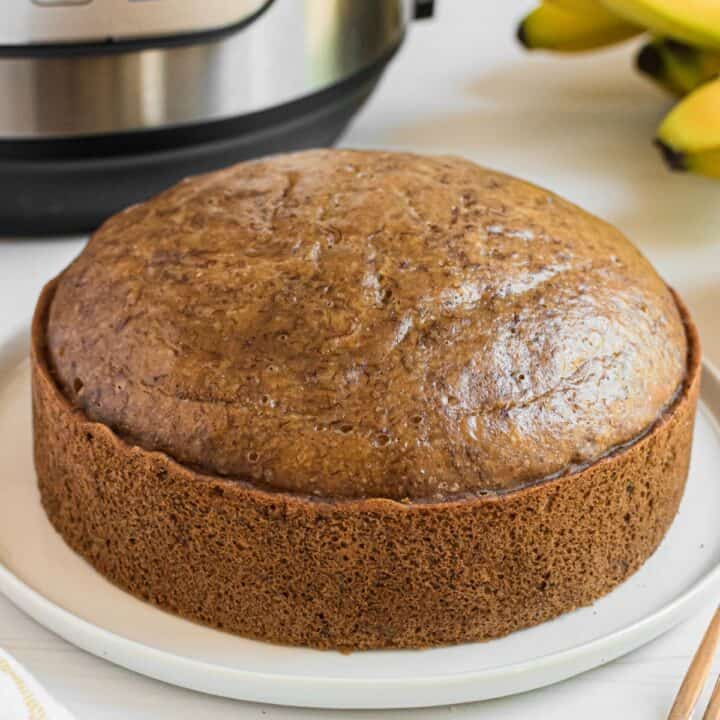 Banana Bread made in the pressure cooker on a white serving plate.