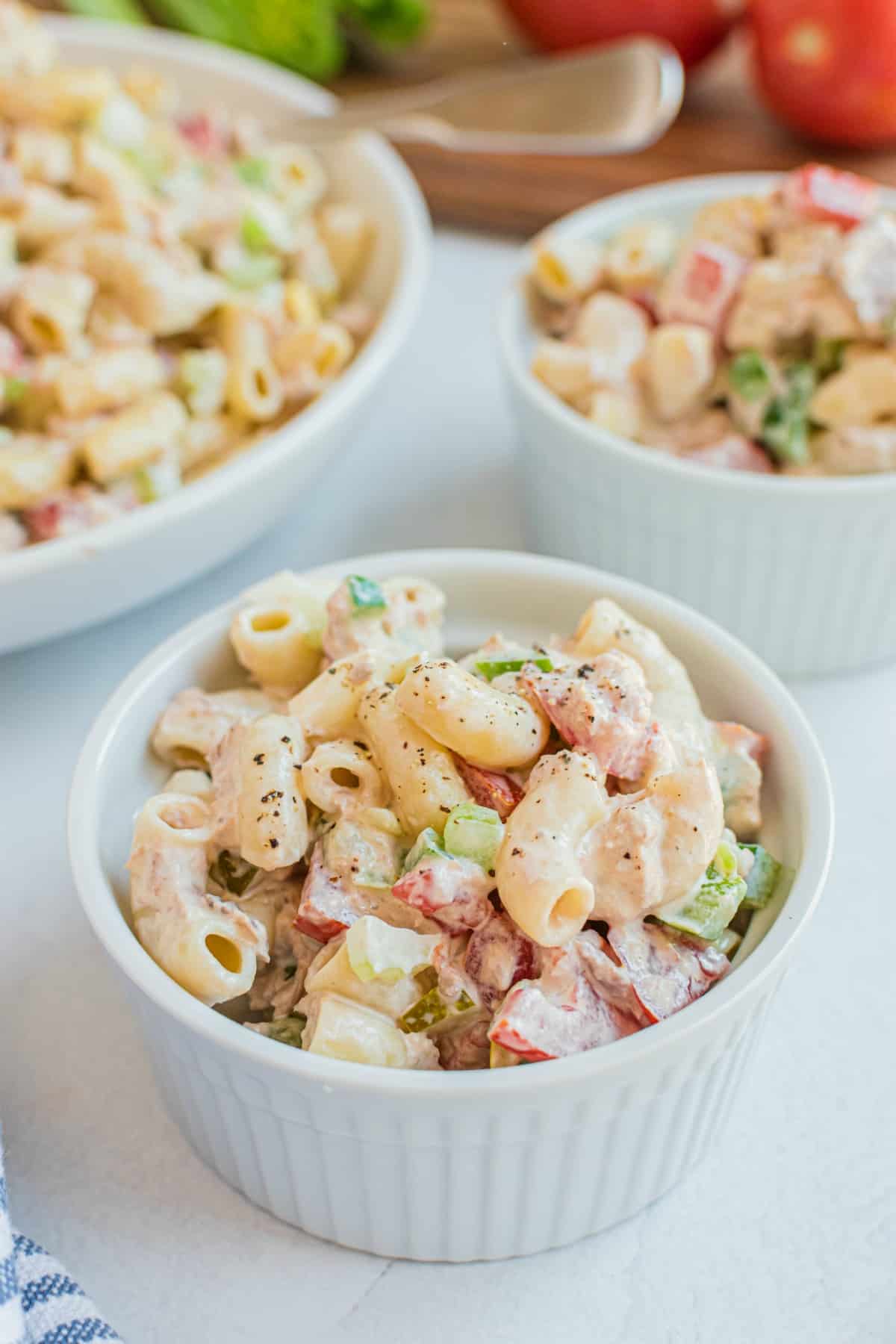 Macaroni salad served in small white ramekins.