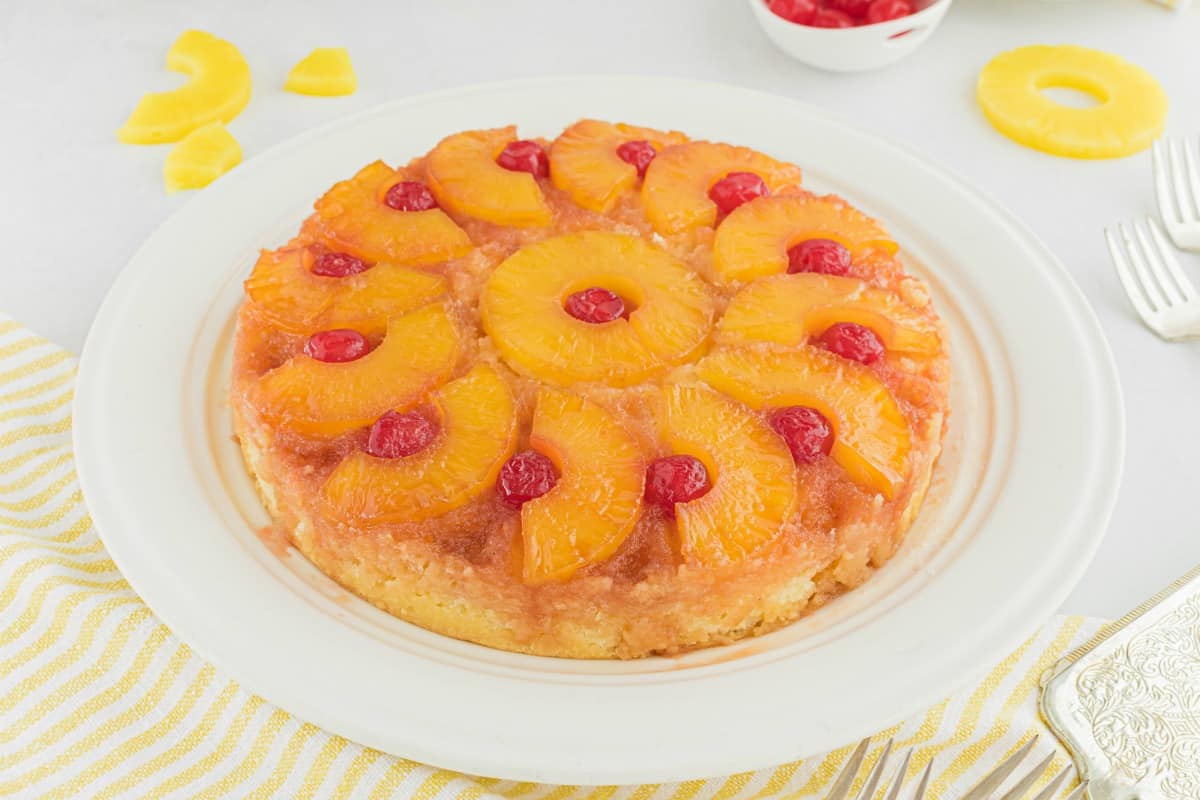 Pineapple Upside down cake served on a white cake platter.