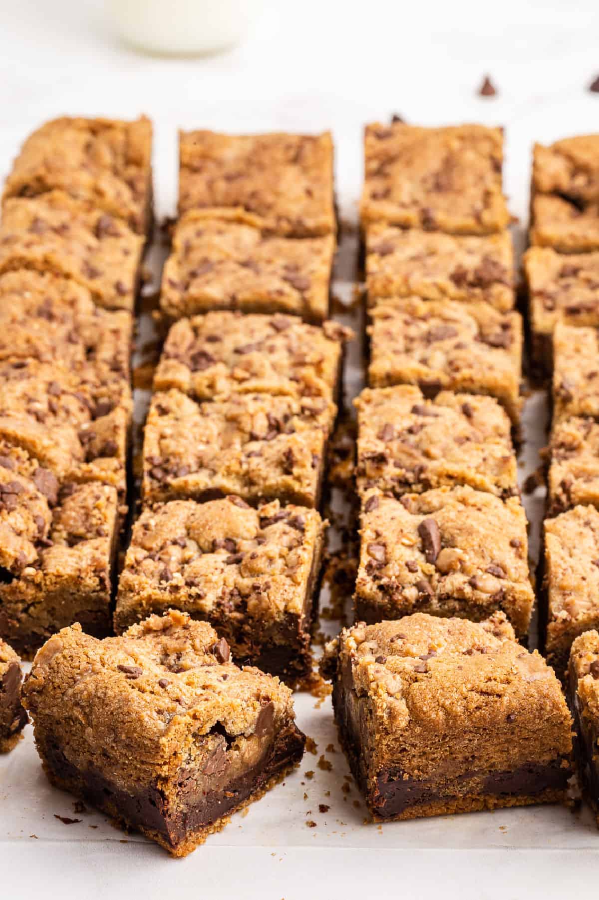 Toffee chocolate chip cookie bars with a layer of fudge cut into squares.