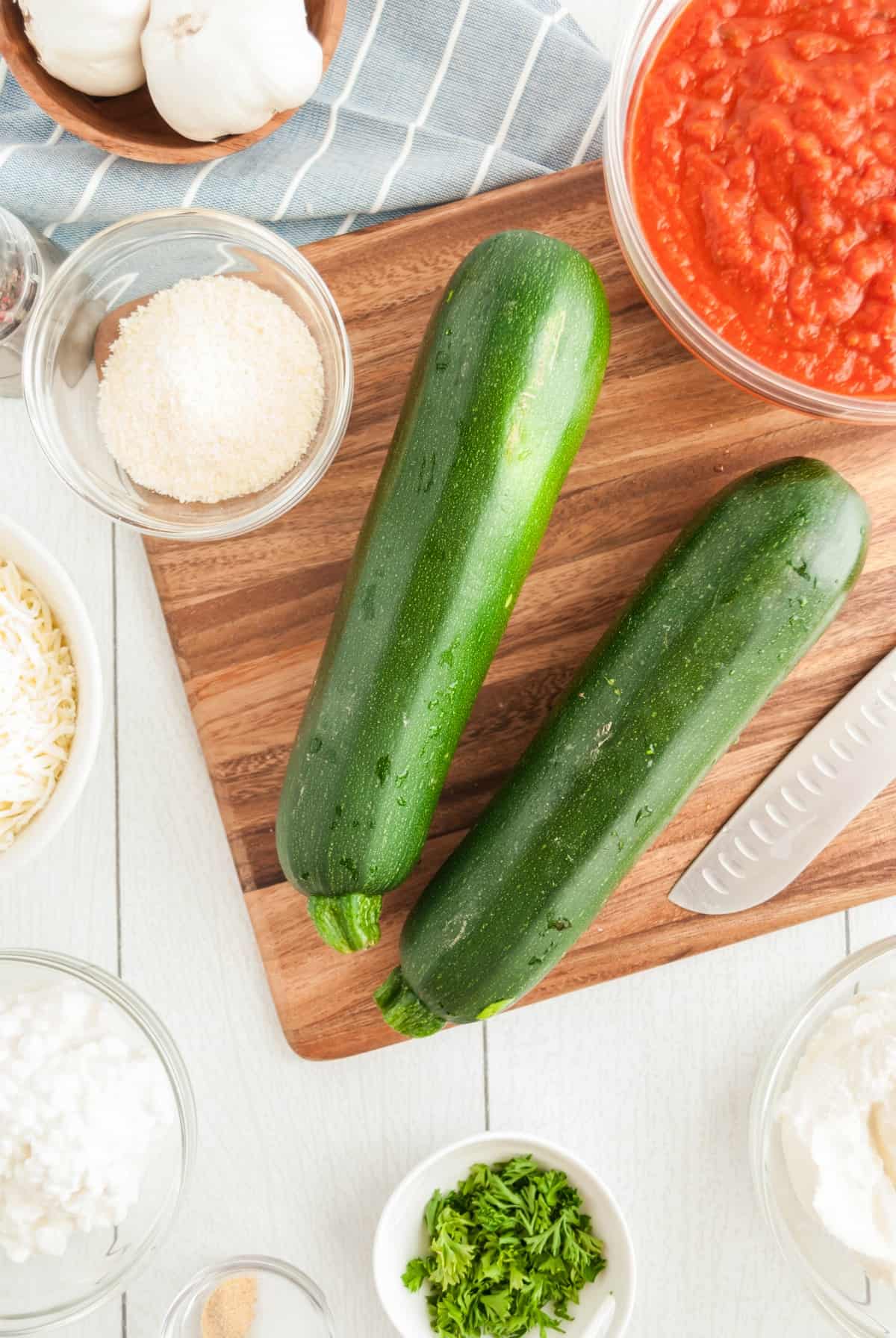 Ingredients needed for vegetarian lasagna roll ups with zucchini and ricotta filling.